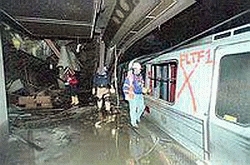 Subterranean PATH tunnel showing intact rail infrastructure and tunnel arches directly beneath tower footprint
